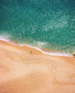 drone shot of a person at the beach